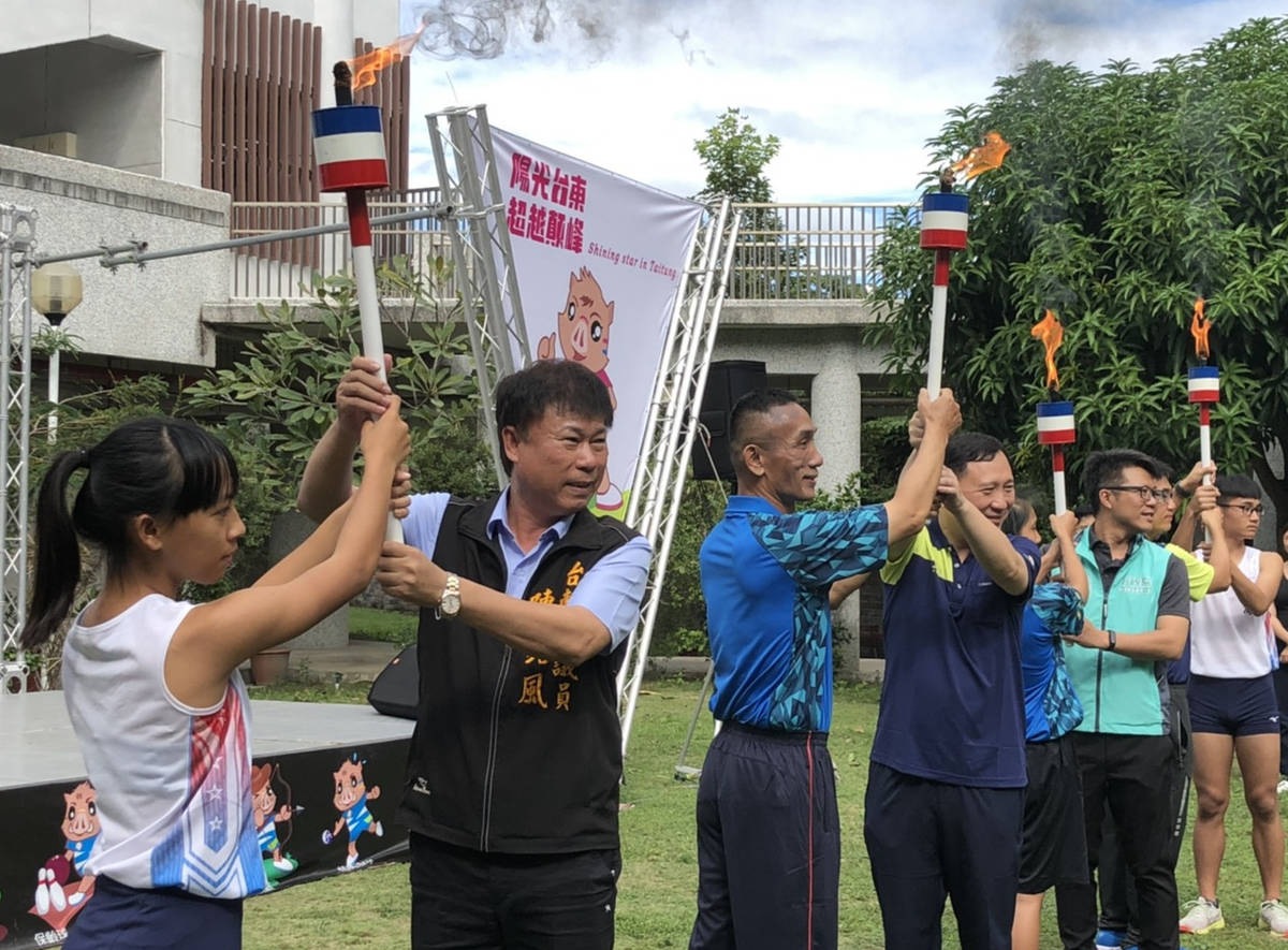 臺東縣體育會陳理事長(左二)與王副縣長(左四)等人，將聖火火把傳遞給聖火隊員，宣告全障運賽事啟動。