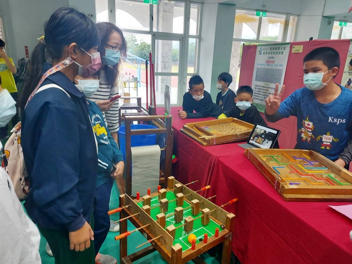 關山國小學生胡嘉祐(右)將舊桌椅創意改造，設計成彈珠檯、手足球檯等懷舊桌遊，獲得金牌與特別獎雙料肯定。