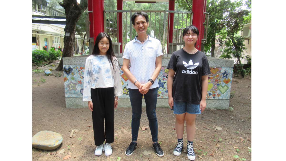 張哲溢(中)與獨輪車隊學生合影。