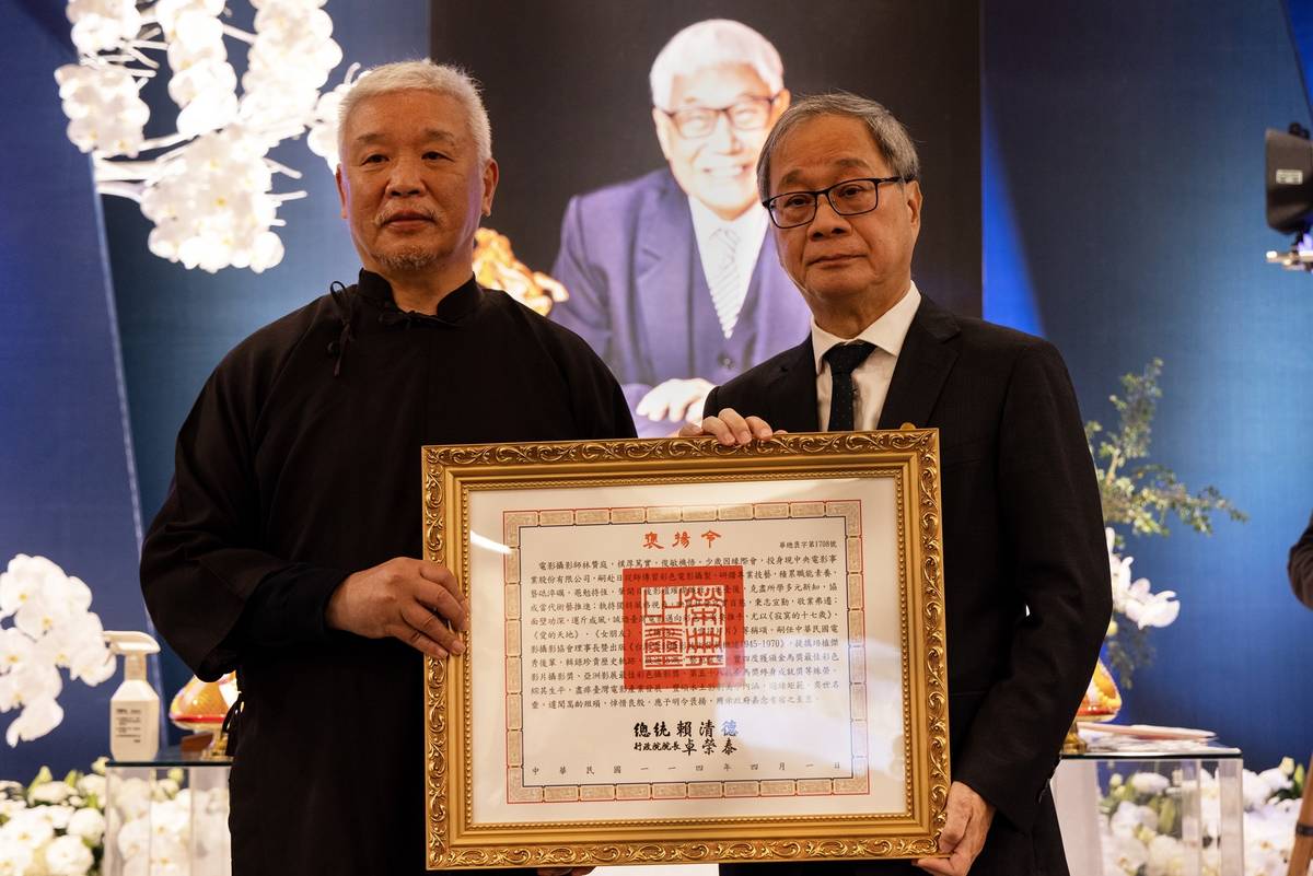 文化部長李遠（右）今出席電影攝影師林贊庭告別式，並代表頒贈總統褒揚令，由林贊庭長子林良忠（左）代表受贈。(文化部提供)