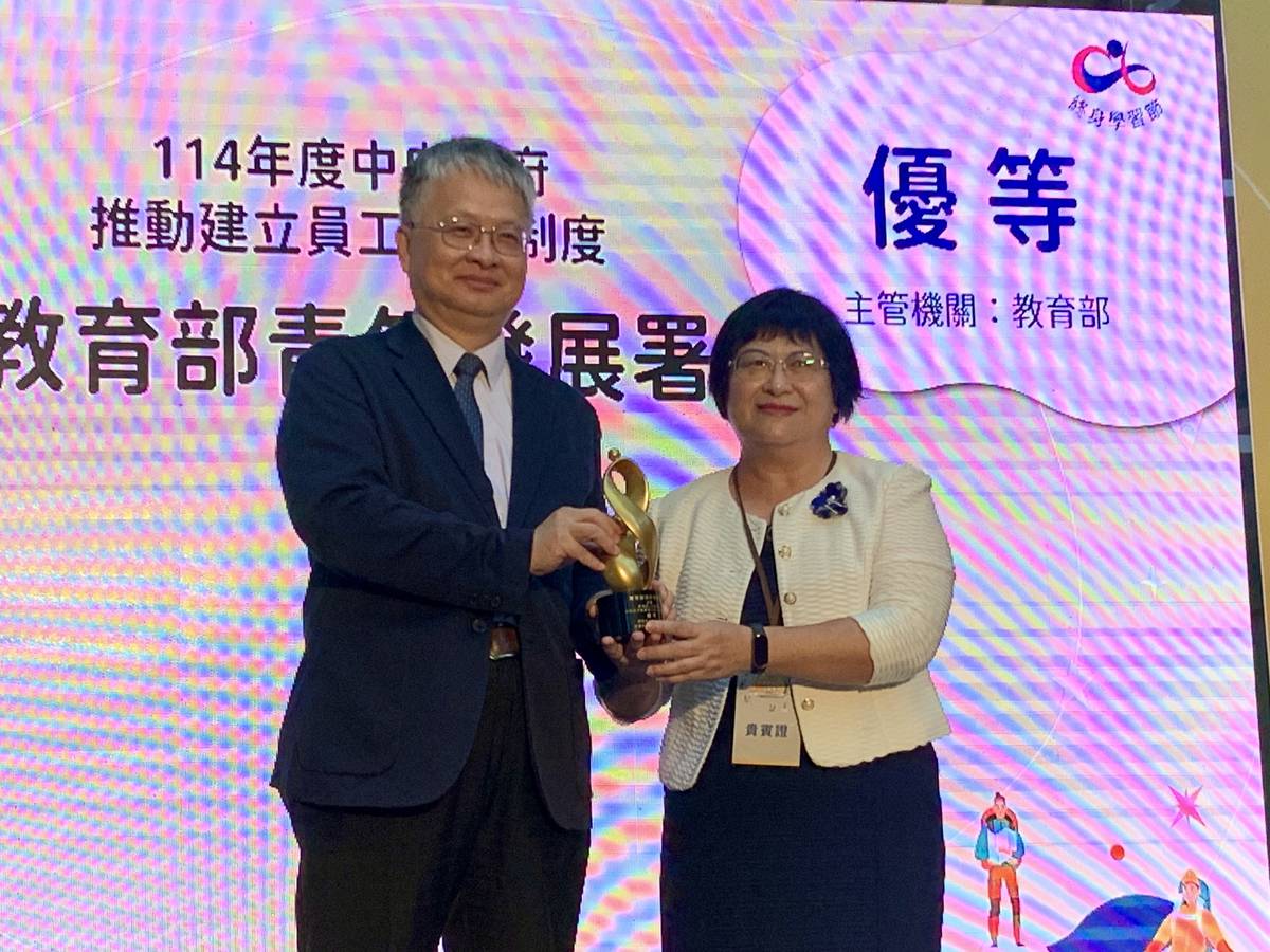 劉國偉次長(左)頒發中央政府推動建立員工學習制度之績優單位給教育部青年發展署，由陳雪玉署長接過獎座 (記者攝)