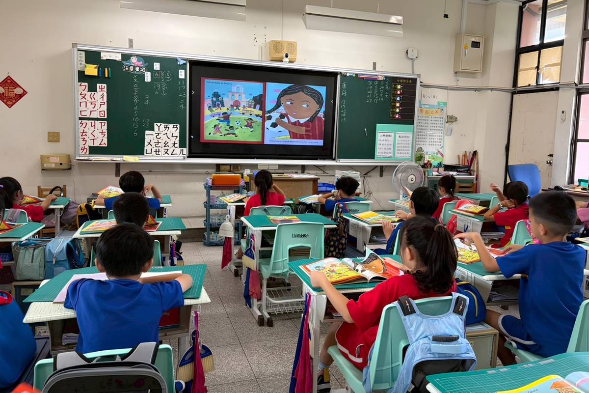 高雄市前金國小學童以紙本繪本搭配電子有聲書進行閱讀，透過聲音與圖像的結合提升理解與專注度(教育部提供)