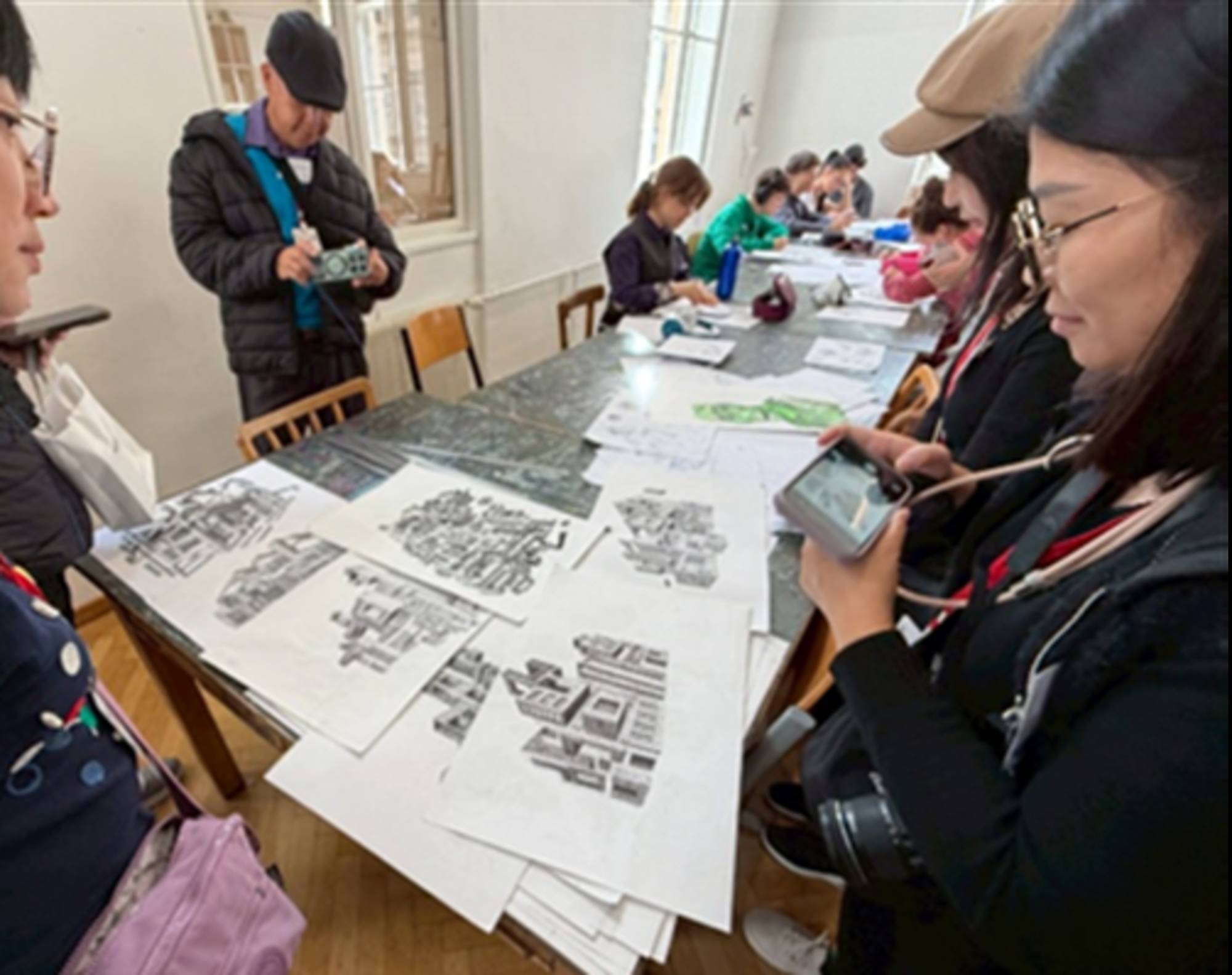 The Taiwanese teachers viewing student drawings during their visit to BORG Hegelgasse